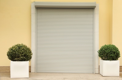 Photo of Building with closed roller shutter door. Exterior design