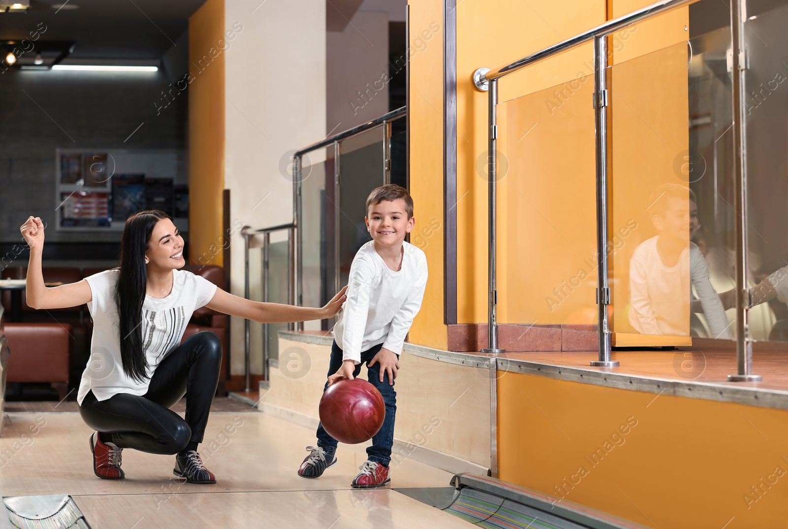 Photo of Mother and son spending time together in bowling club