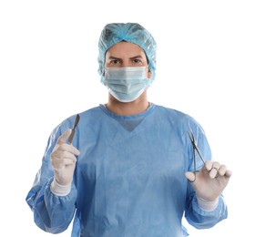 Photo of Doctor holding medical clamps and scalpel on light background. Surgical instruments