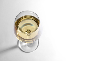 Photo of Glass of delicious wine on white background, above view