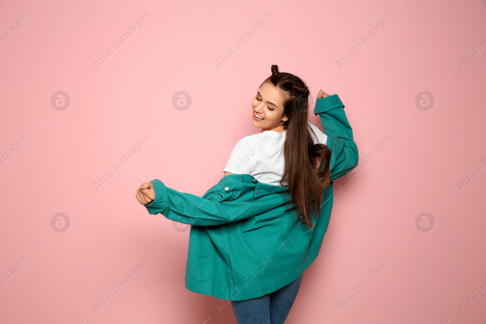 Photo of Portrait of beautiful young woman in stylish clothes on color background