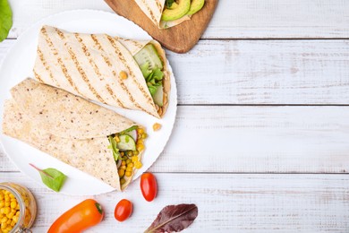 Photo of Plate with hummus wraps and vegetables on white wooden table, flat lay. Space for text
