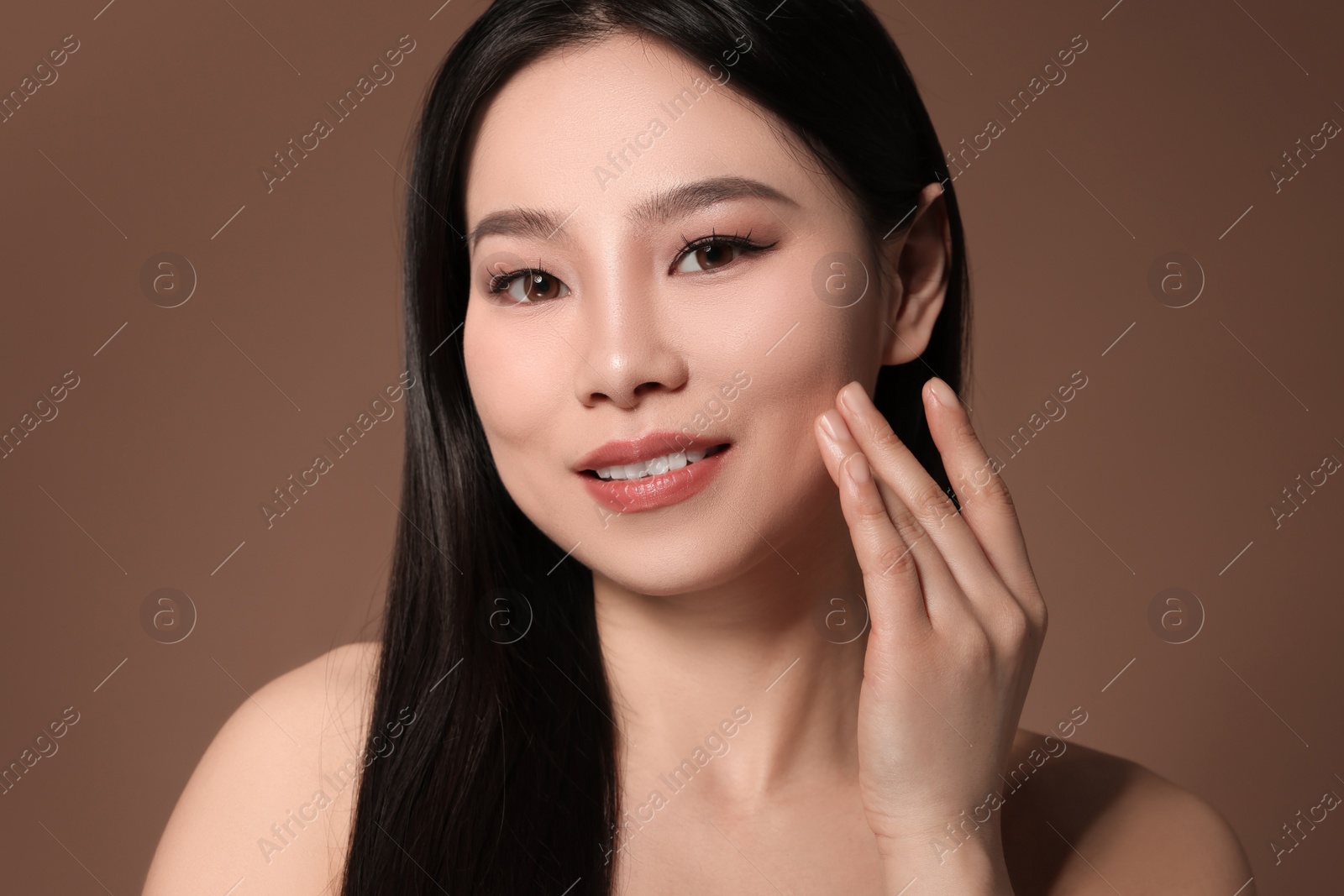 Photo of Portrait of beautiful woman on brown background