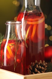 Aromatic punch drink and Christmas decor on blurred background, closeup