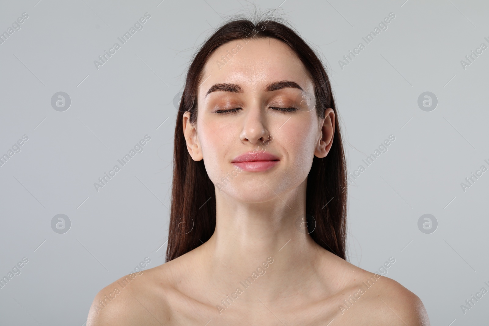 Photo of Portrait of beautiful young woman on light grey background