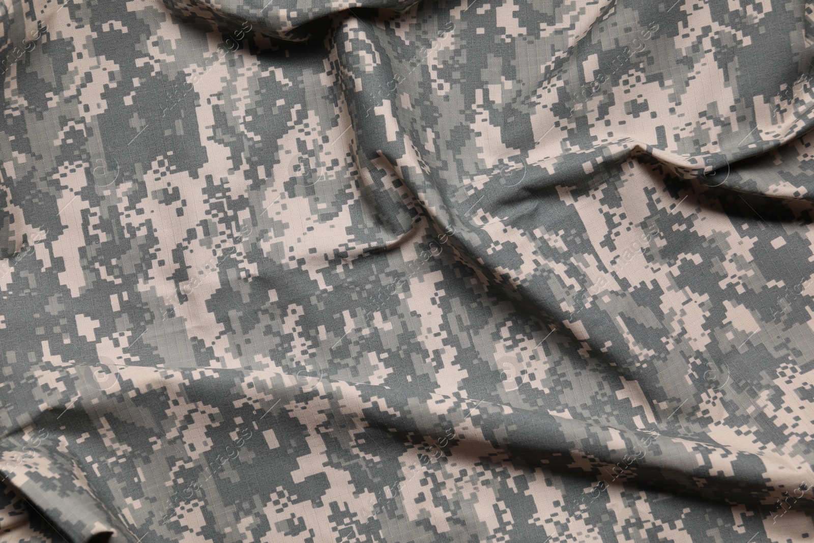 Photo of Texture of crumpled camouflage fabric as background, top view