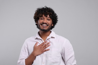 Handsome smiling man on light grey background