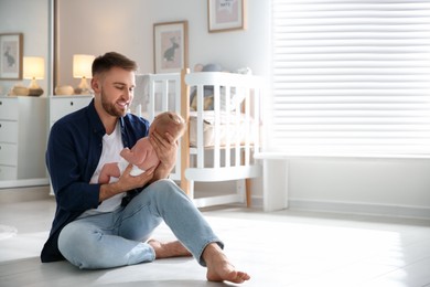 Photo of Father with his newborn son at home. Space for text