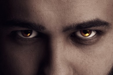 Image of Evil eye, captivating gaze. Man with rare eye color, closeup