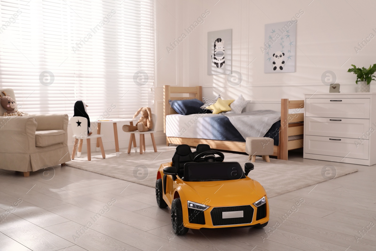 Photo of Empty yellow toy car for child in light room