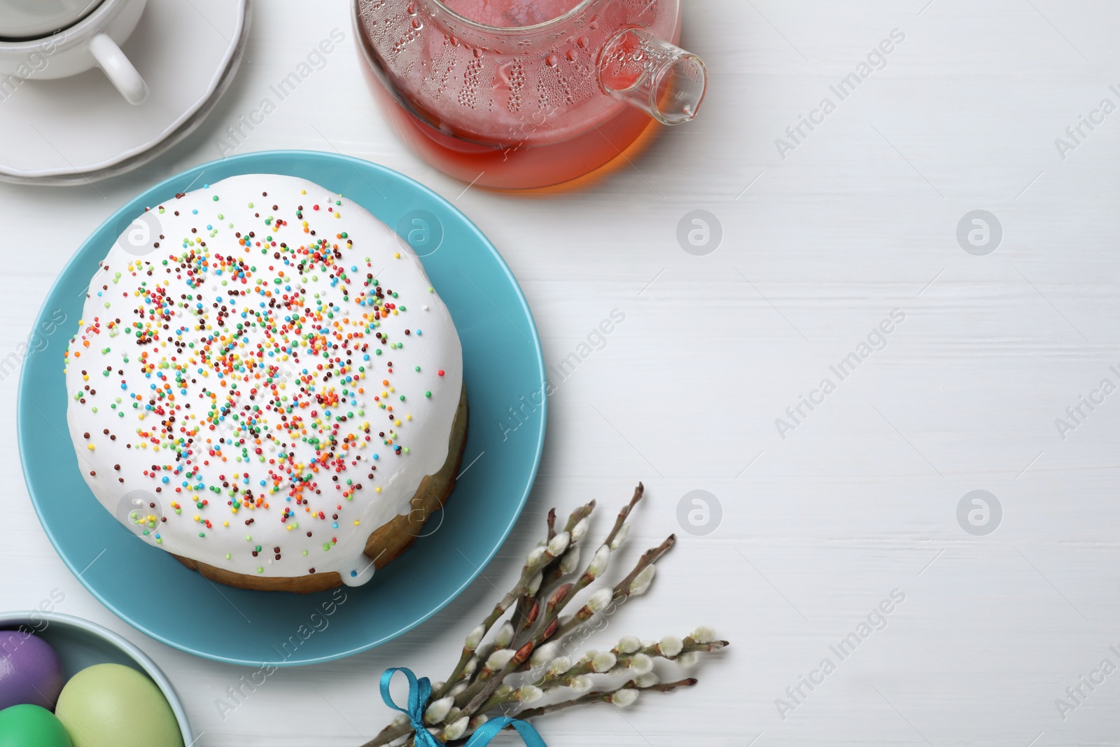 Photo of Easter cake served on white wooden table, flat lay. Space for text