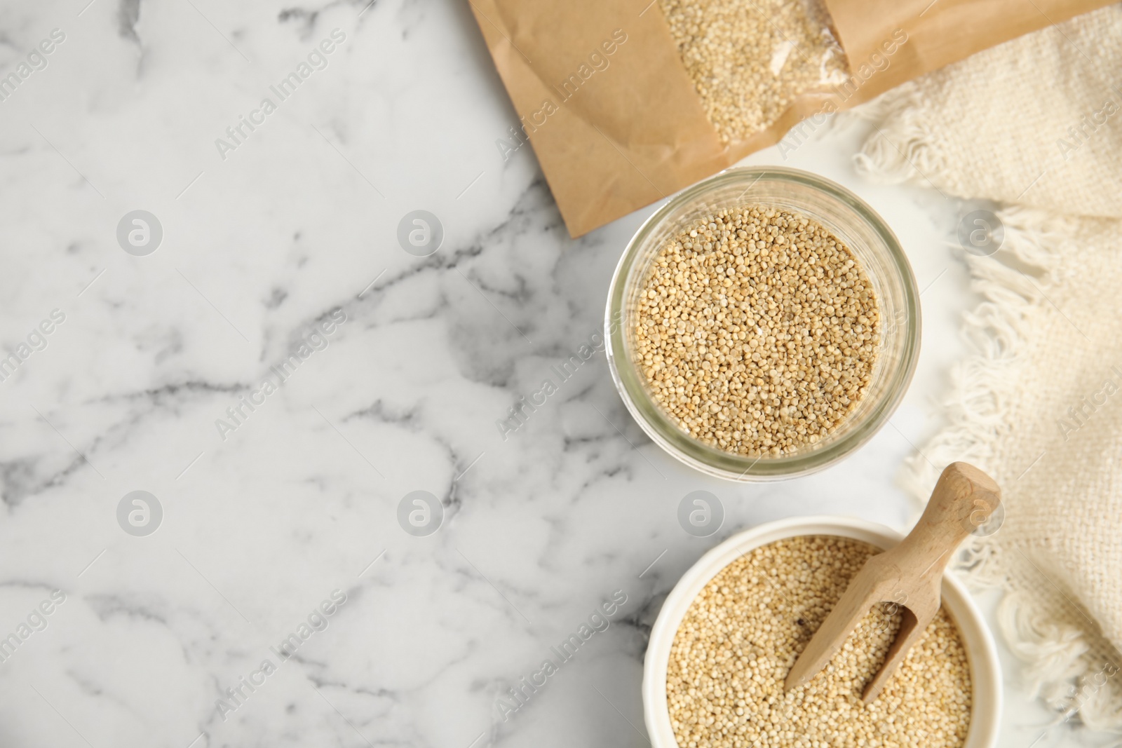 Photo of White quinoa on marble table, flat lay. Space for text