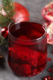 Aromatic Sangria cocktail in glass on grey table, closeup. Christmas drink