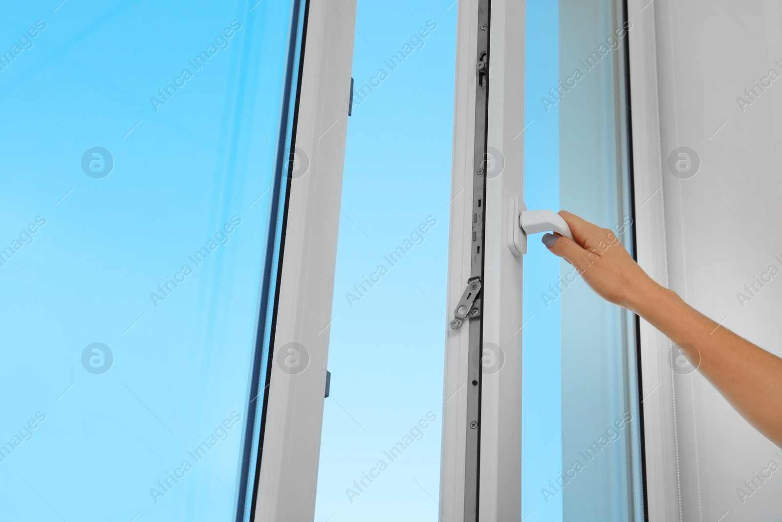 Photo of Woman opening new modern window, closeup view