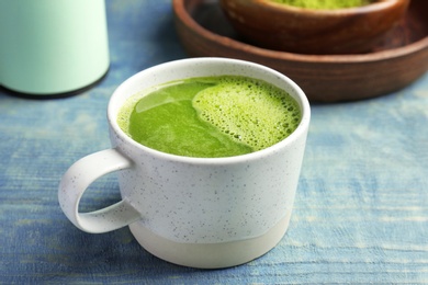 Photo of Cup of fresh matcha tea on table