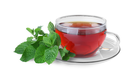 Photo of Cup with hot aromatic mint tea and fresh leaves isolated on white