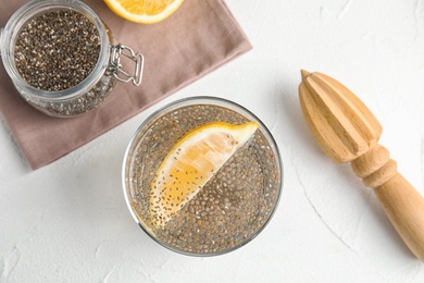 Photo of Flat lay composition with glass of water and chia seeds on white background
