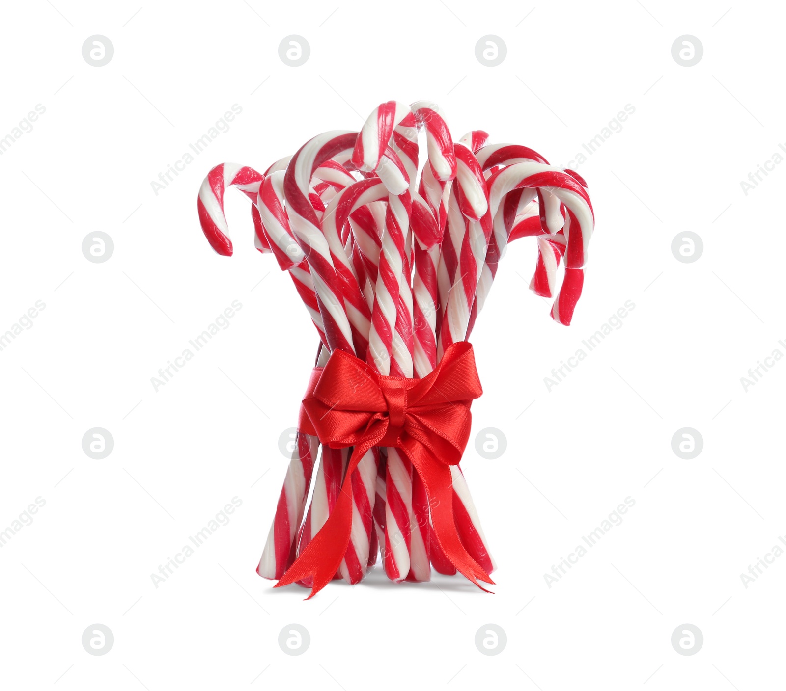 Image of Bunch of sweet candy canes with red bow on white background. Christmas treat