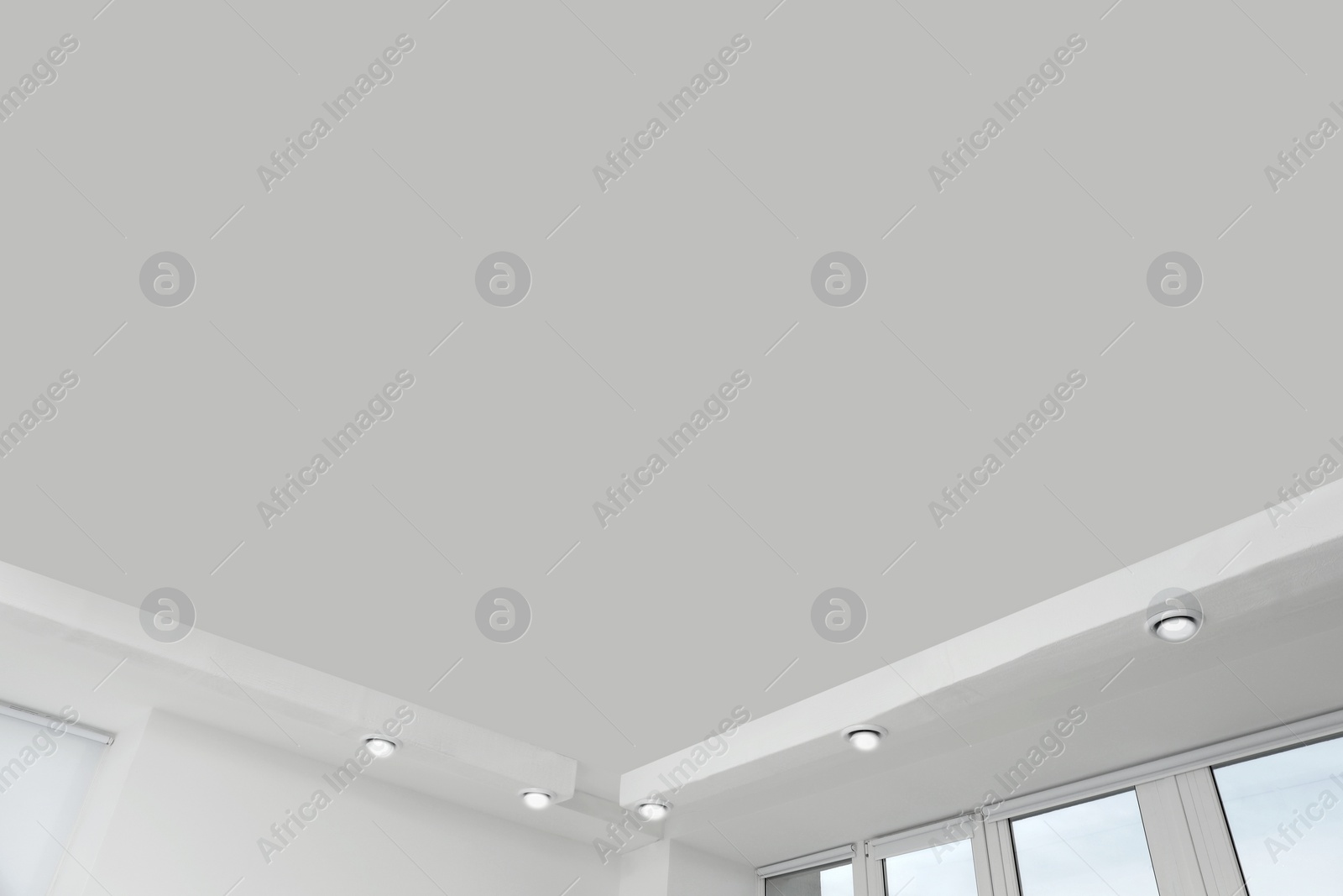 Photo of White ceiling with modern lighting in office