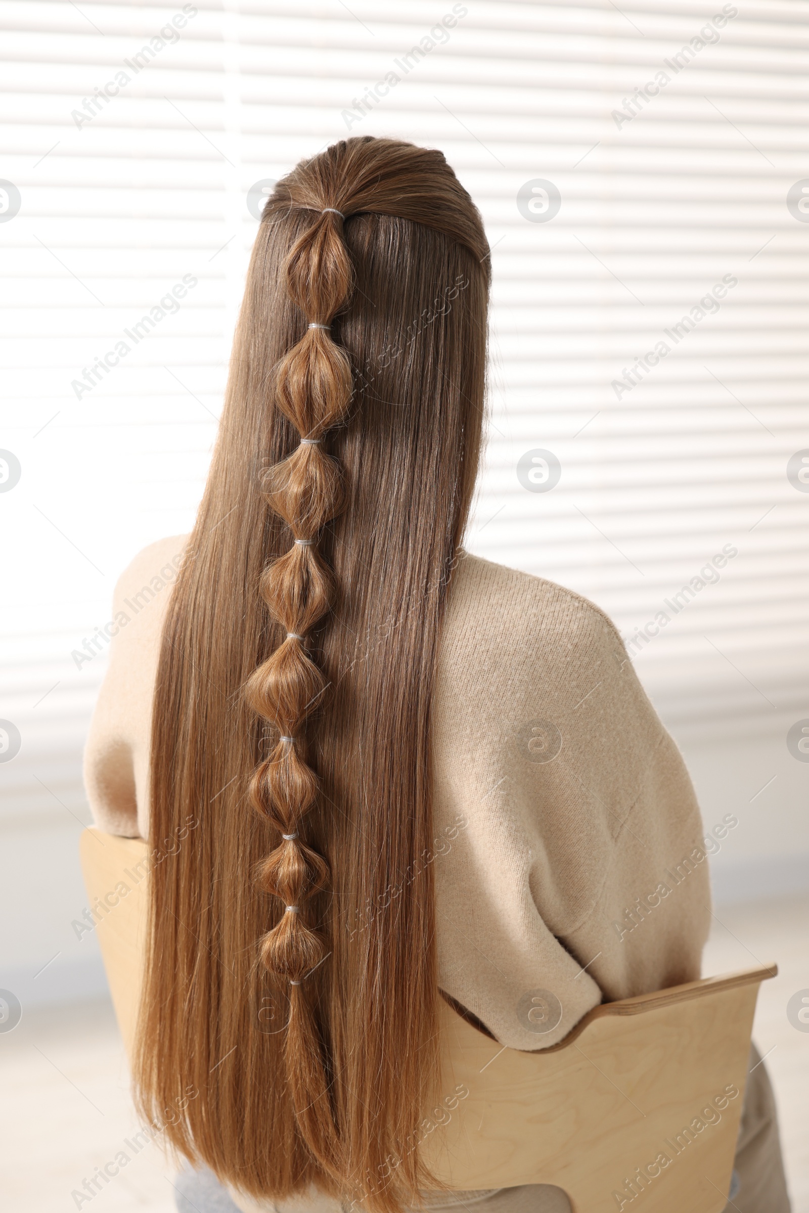 Photo of Woman with braided hair indoors, back view