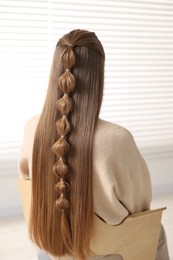 Photo of Woman with braided hair indoors, back view