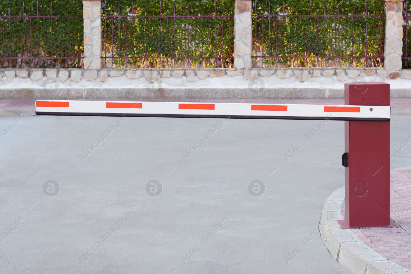 Photo of Closed boom barrier near road on autumn day outdoors