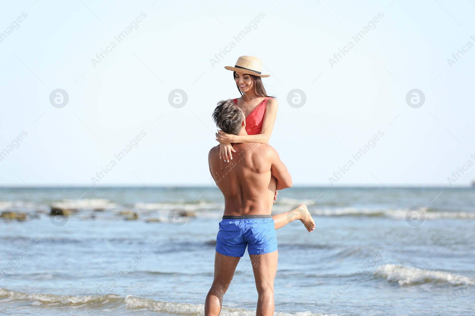 Photo of Happy young couple having fun at beach on sunny day