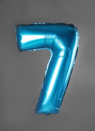 Photo of Blue number seven balloon on grey background
