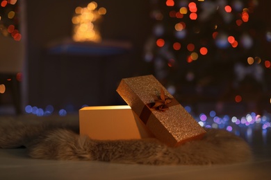 Photo of Open gift box and Christmas tree in dark room