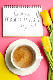 Photo of Delicious coffee, beautiful flowers and GOOD MORNING wish on color background, flat lay