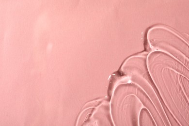 Cosmetic gel on pink background, top view. Space for text