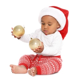 Photo of Festively dressed African-American baby with Christmas decorations on white background