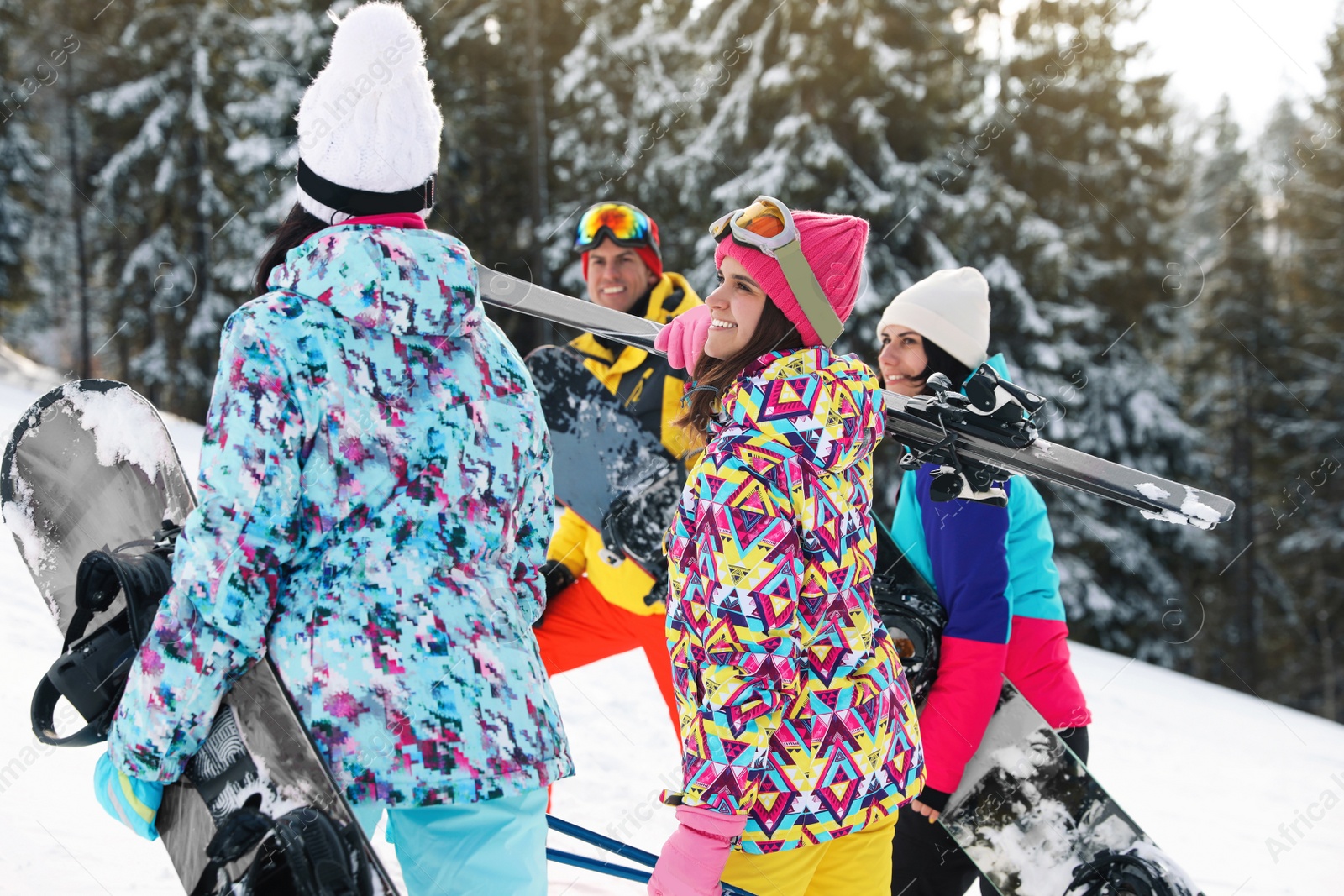 Photo of Group of friends with equipment in snowy mountains. Winter vacation