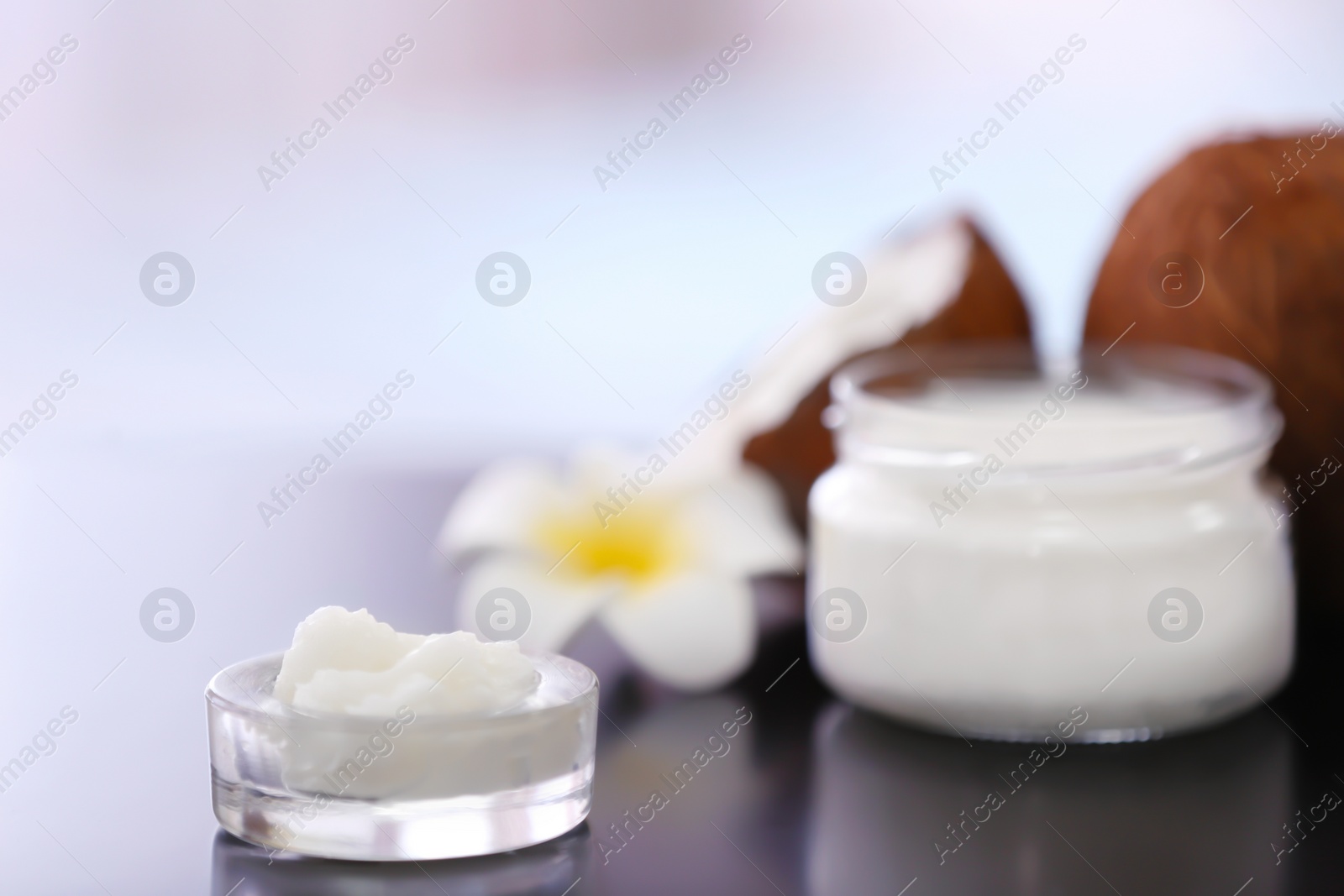 Photo of Composition with coconut butter in glass jar on blurred background