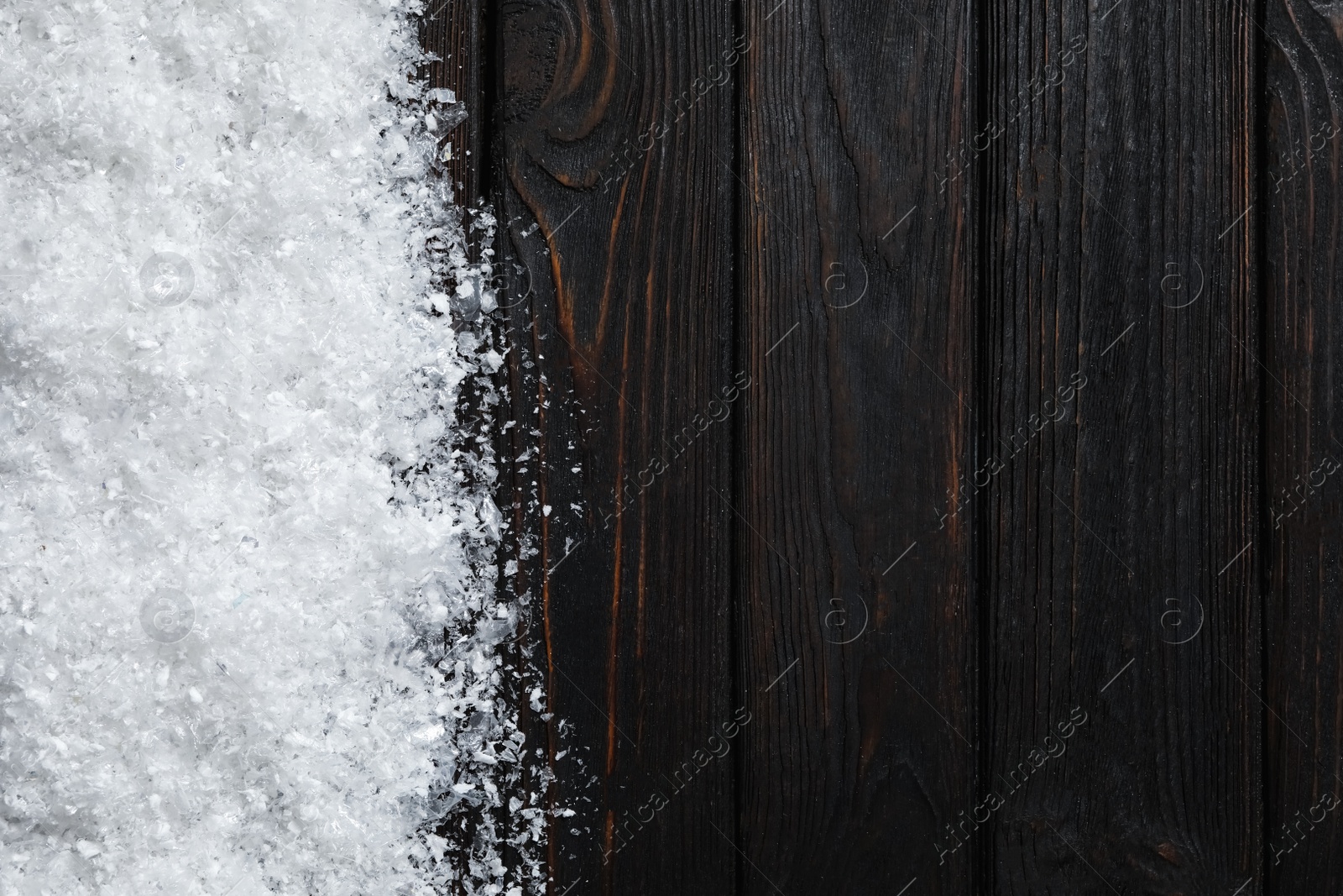 Photo of Snow and space for text on wooden background, top view. Christmas time