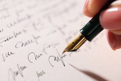 Photo of Woman writing letter with fountain pen, closeup