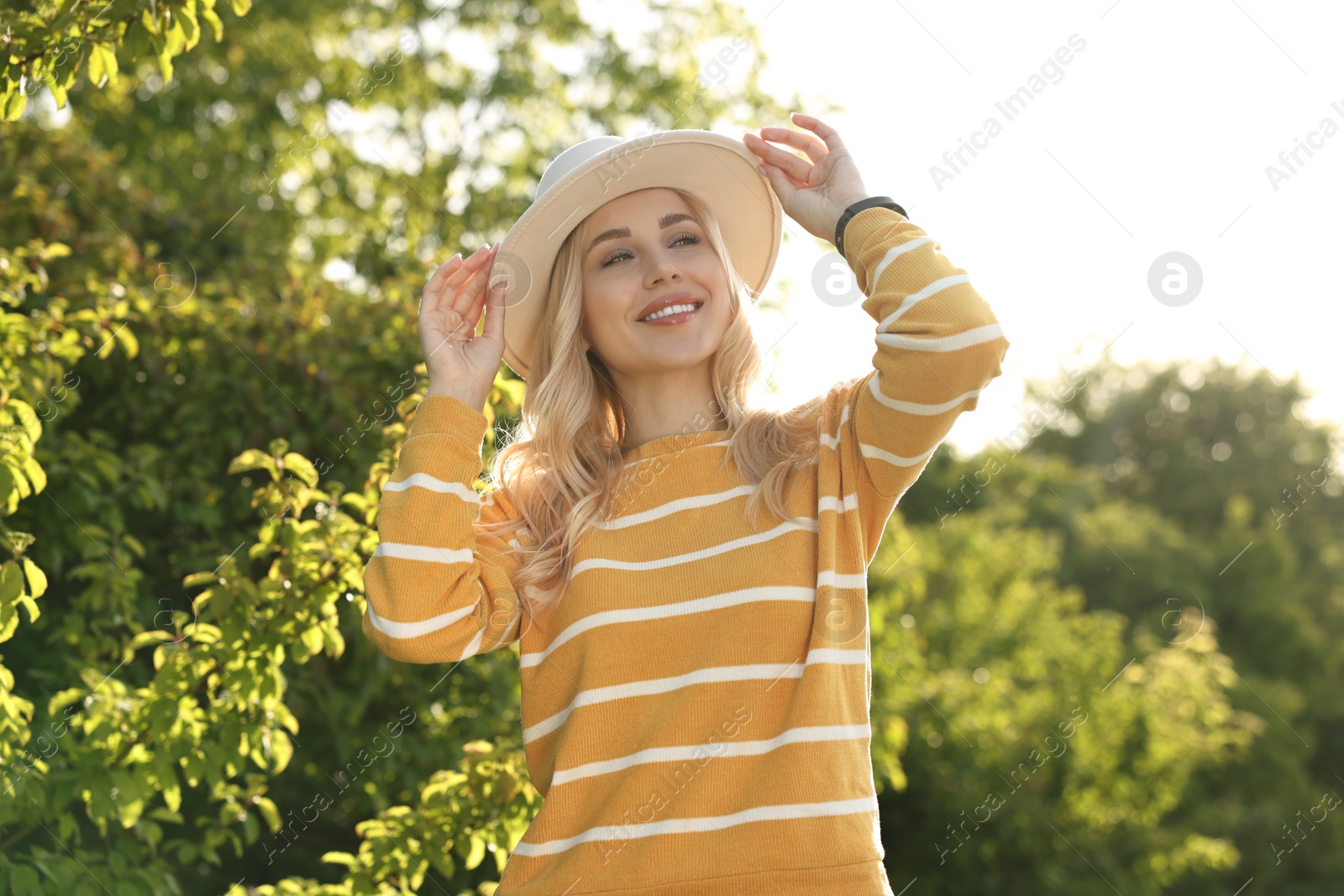 Photo of Portrait of happy young woman in park on spring day