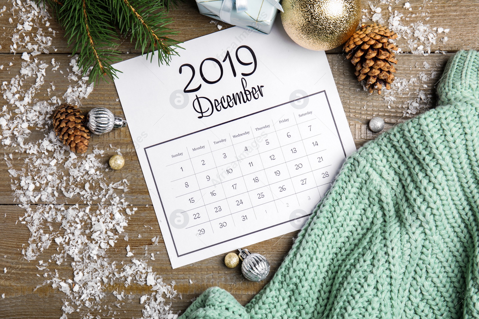 Photo of Flat lay composition with paper calendar on wooden table