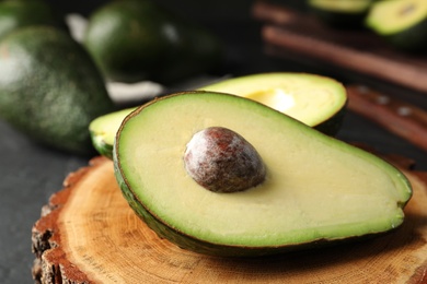 Half of delicious ripe avocado on table