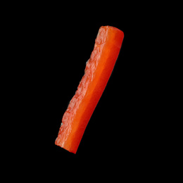 Photo of Piece of red bell pepper on black background