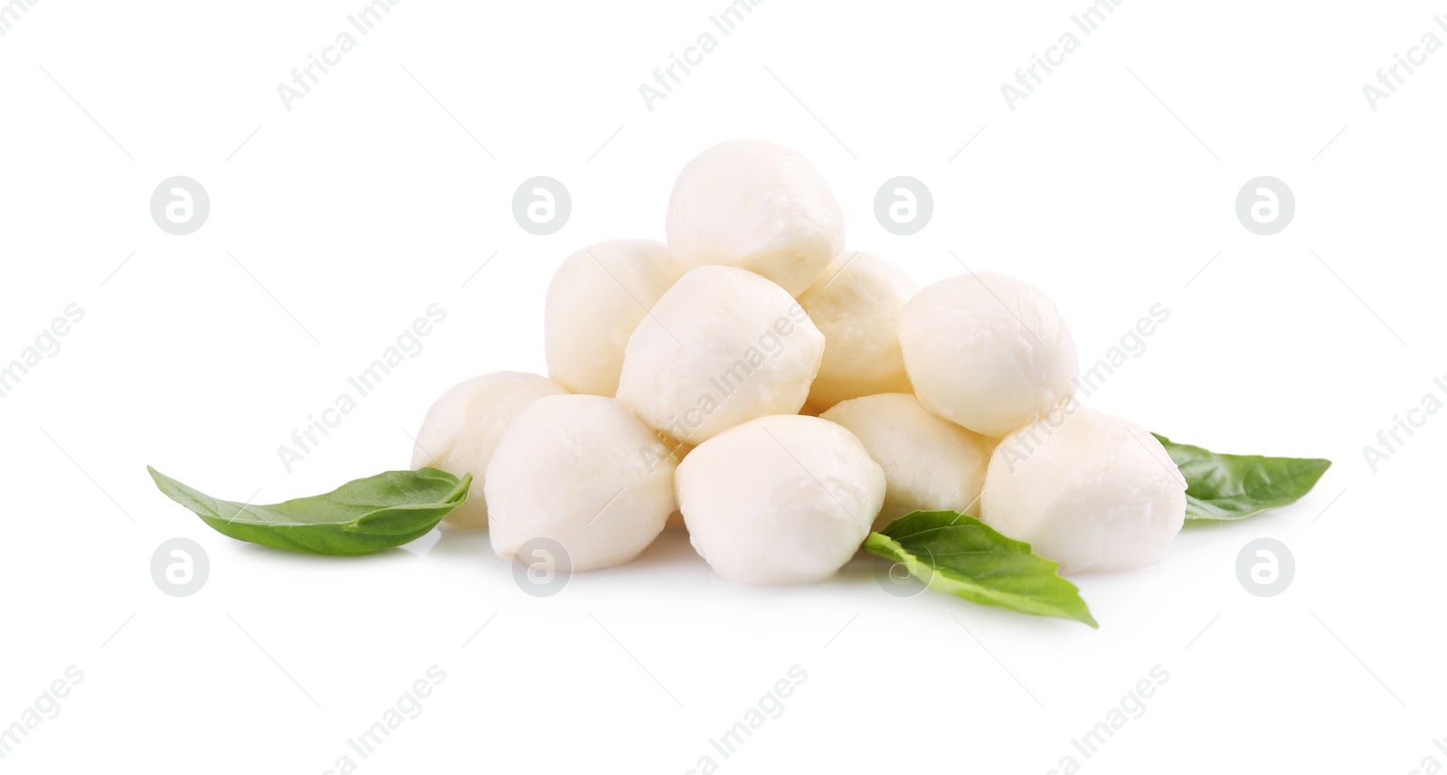 Photo of Tasty mozzarella balls and basil leaves isolated on white