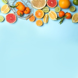 Different citrus fruits on color background, top view. Space for text