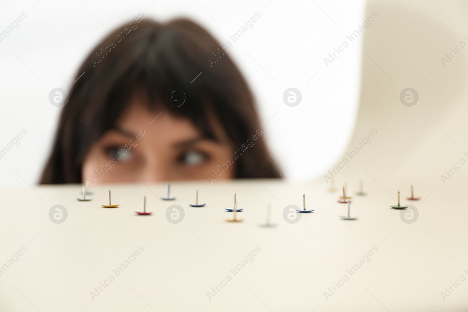 Photo of Young woman near chair with pins, closeup. April fool's day