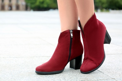 Woman wearing comfortable stylish boots outdoors, closeup