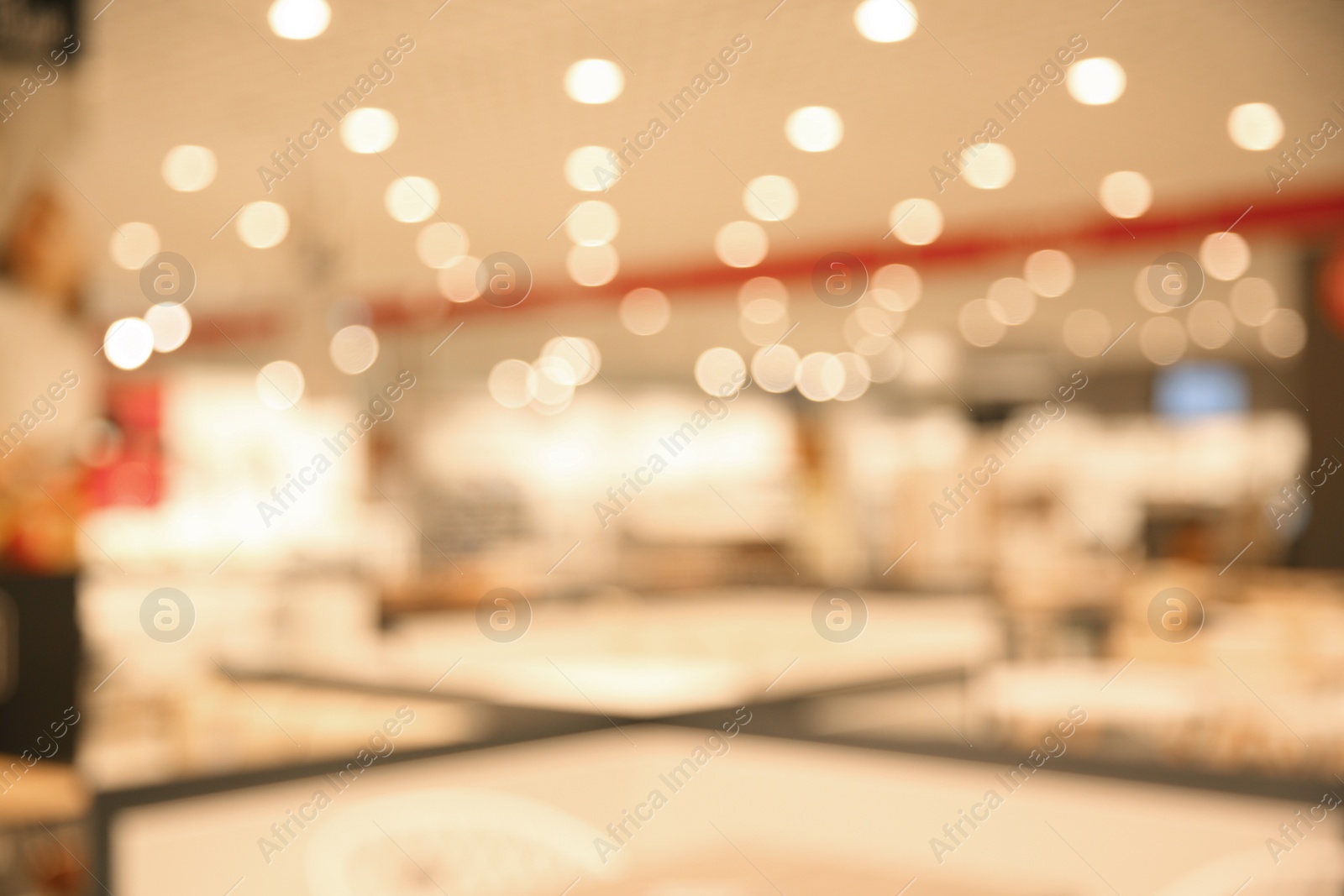 Photo of Blurred view of modern shopping mall interior