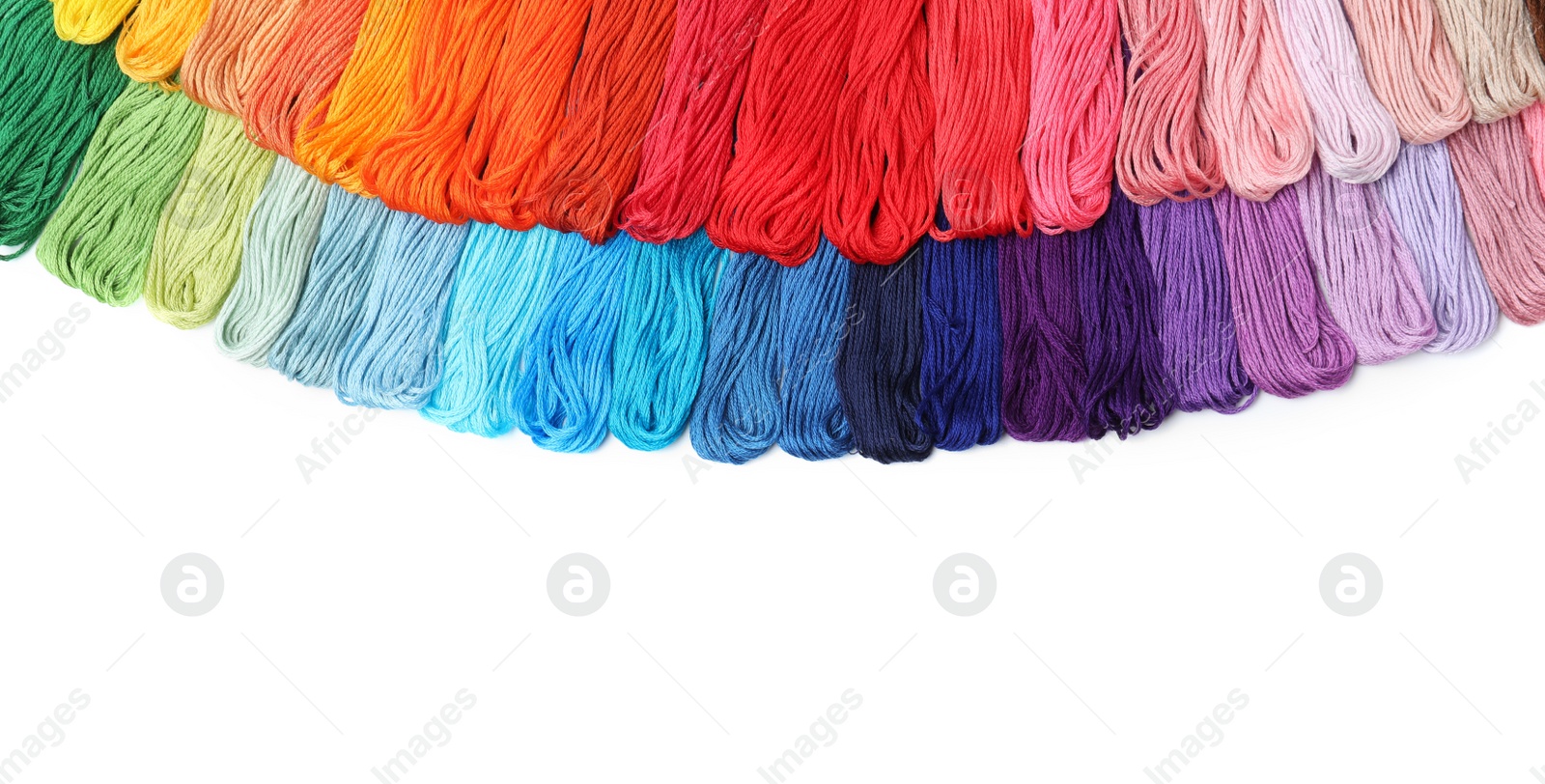 Photo of Set of colorful embroidery threads on white background, top view