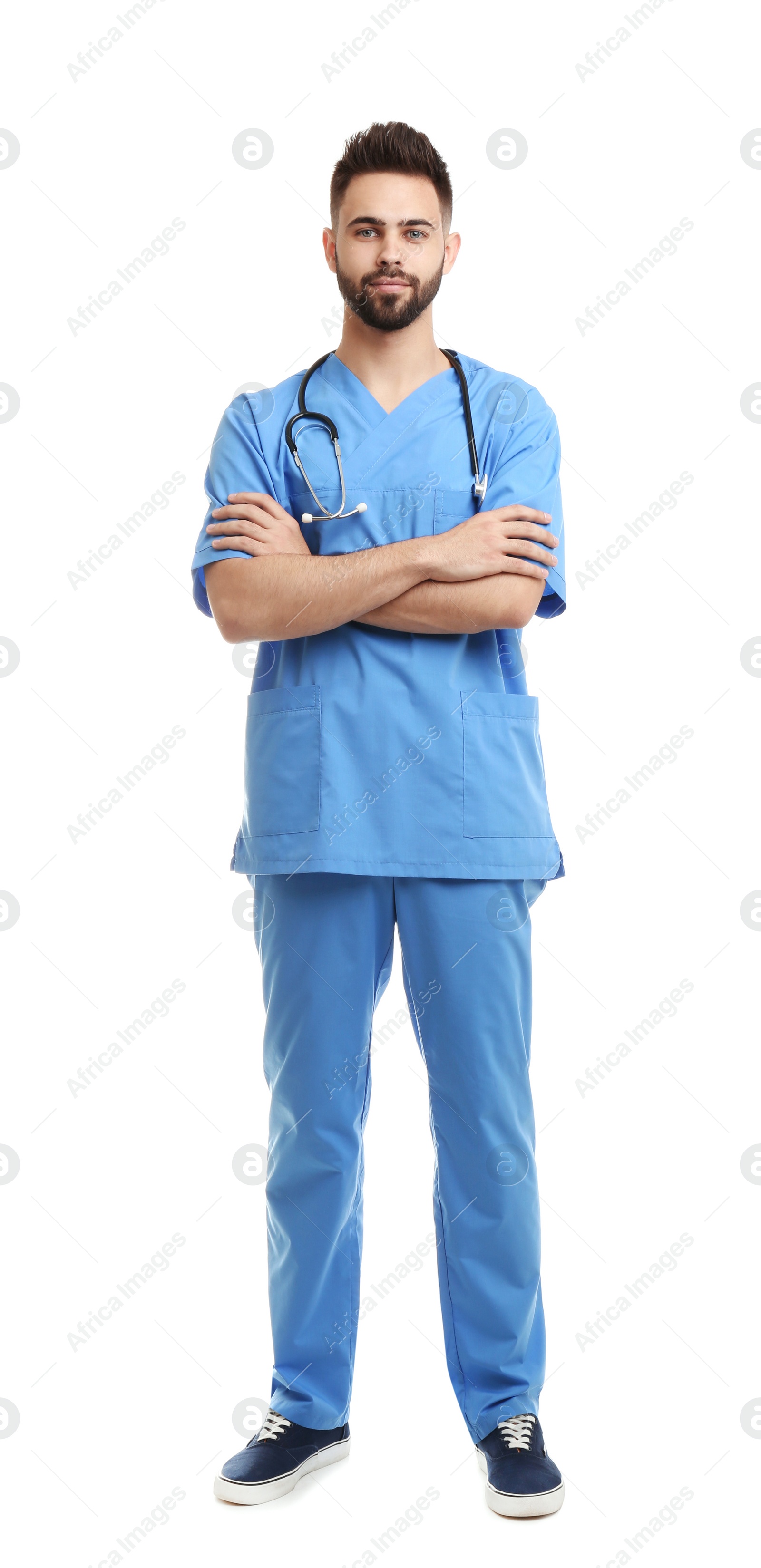 Photo of Young male doctor in uniform isolated on white