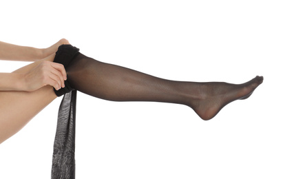 Photo of Woman putting on tights on white background, closeup