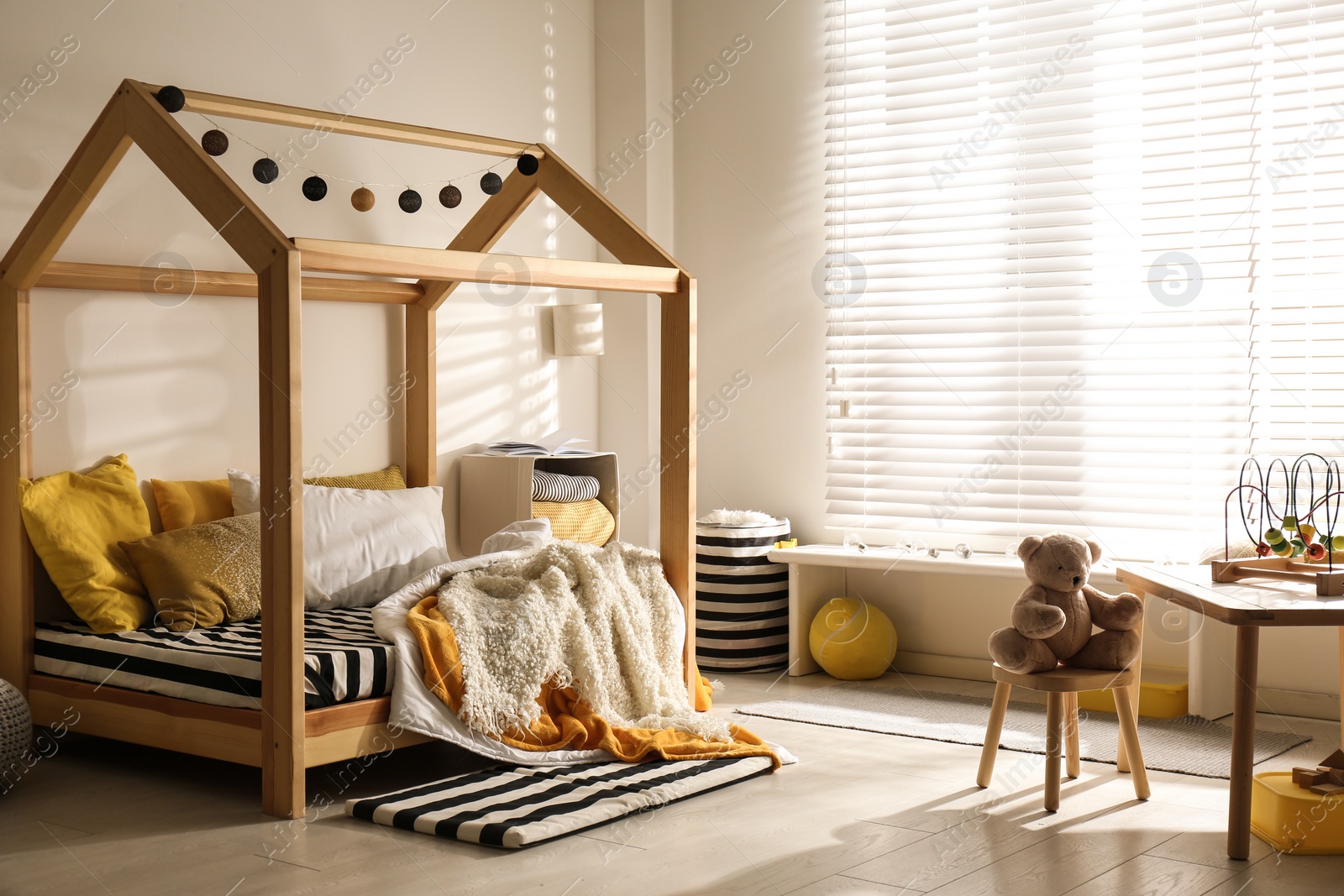 Photo of Cozy child room interior with comfortable bed