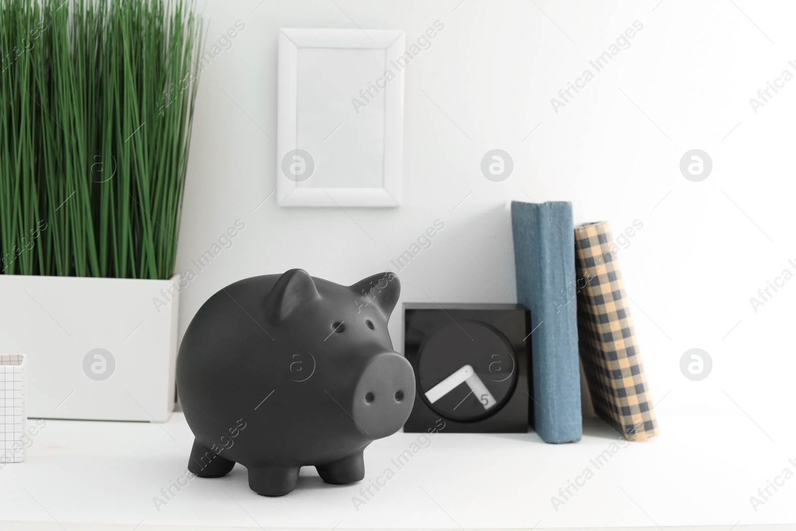 Photo of Cute piggy bank on table indoors. Stylish interior